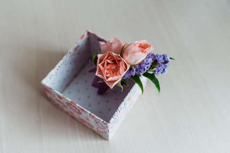 Boutonniere groom with a pink rose, in a box. close-upの写真素材