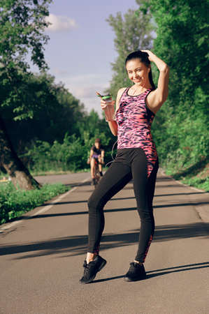 Young woman is thirsty for drinking water for recovery after runningの写真素材