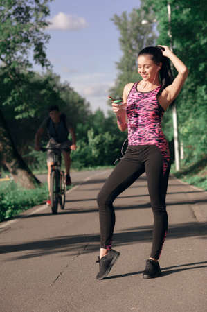 Young woman is thirsty for drinking water for recovery after runningの写真素材
