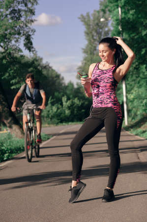 Young woman is thirsty for drinking water for recovery after runningの写真素材