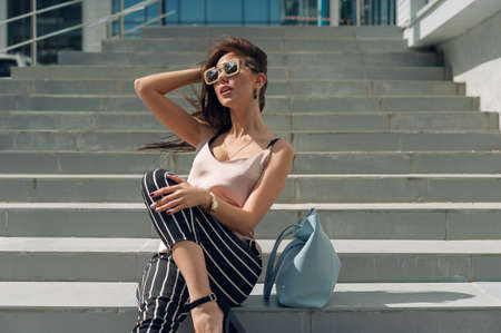 Beautiful young woman standing at the entrance to the underground garage.の写真素材