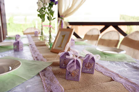 Beautifully decorated table for the wedding ceremony. Served banquet table decorated with fresh flowers in the open air.の写真素材