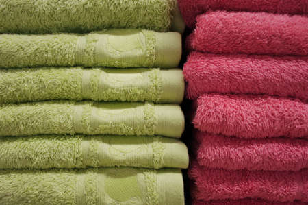 bath towels of bright colors in a row in a row on the counter of a store counterの写真素材