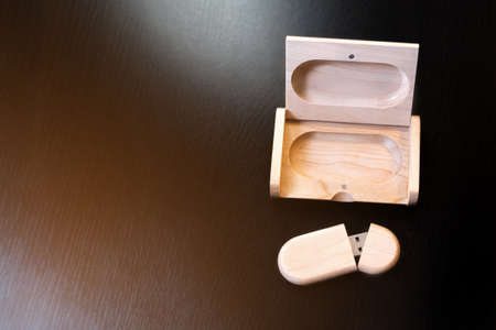 wooden usb flash drive on a black table.の写真素材