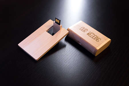 wooden usb flash drive on a black table.の写真素材