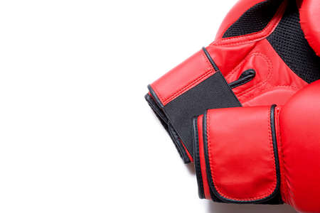 Leather box equipment for fight and training. Pair of boxing gloves lying on each other. Combat and fight concept. Boxing gloves in red color isolated on white background.の写真素材