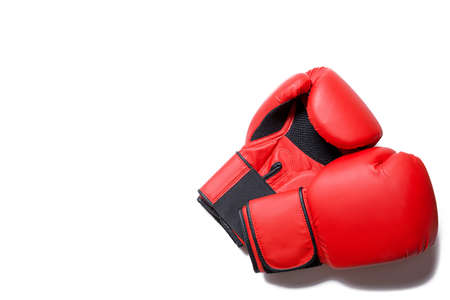 Leather box equipment for fight and training. Pair of boxing gloves lying on each other. Combat and fight concept. Boxing gloves in red color isolated on white background.の写真素材
