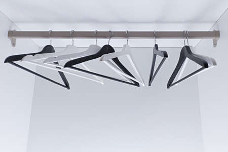 White and black empty clothes hangers, in the wardrobe.の写真素材
