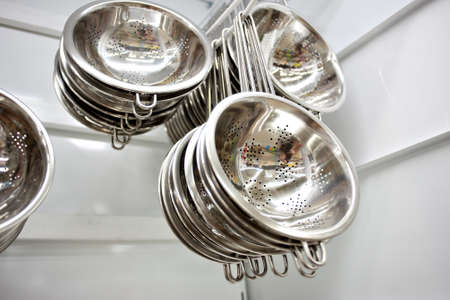 colander hang on the racks in the super store.の写真素材