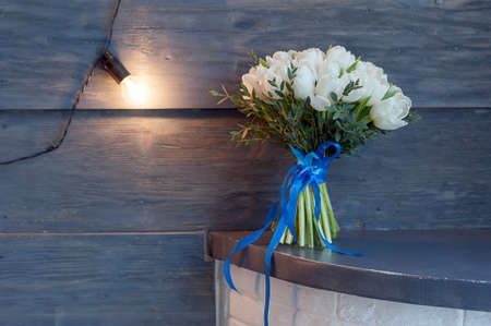 bouquet of white tulips, tied with blue ribbon.の写真素材