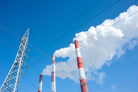 Air pollution by smoke coming from three factory chimneys.の写真素材