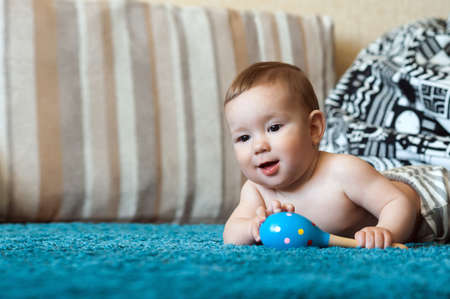 The kid gnaws a rattle, eruption of milk teeth
