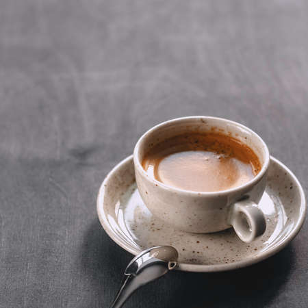 macro photo. light cup of black coffee with chocolate on the rustic table from a height. bokehの写真素材