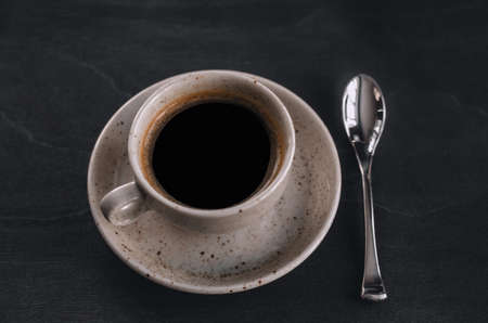 macro photo. light cup of black coffee with chocolate on the rustic table from a height. bokehの写真素材