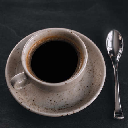 macro photo. light cup of black coffee with chocolate on the rustic table from a height. bokehの写真素材