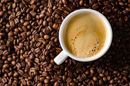 coffee beans background with white cup, copy spaceの写真素材