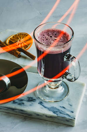 glass mug of mulled wine on marble, dried orange and cinnamonの写真素材