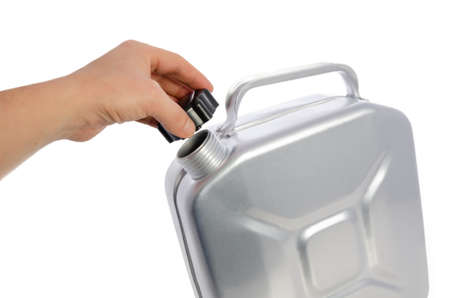 A mans hand opens a metal can for gasoline, isolated on a white background.の写真素材