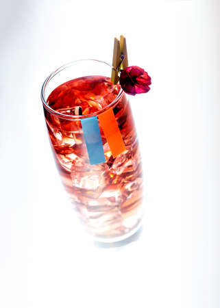 drink in a glass with ice and a decoration on the clothespin. on a white backgroundの写真素材