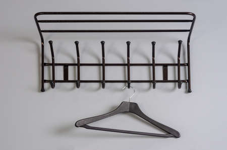 black clothes hanger on a gray wall backgroundの写真素材