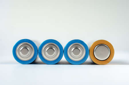 Four blue-golden AA batteries close-up on a white background. shallow depth of field, macroの写真素材