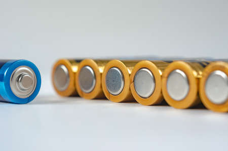 Blue-golden AA batteries close-up on a white background. shallow depth of field, macroの写真素材