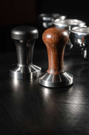 four holders with green, roasted, ground, and hot coffee and tamper, equipment for making freshly brewed coffeeの写真素材