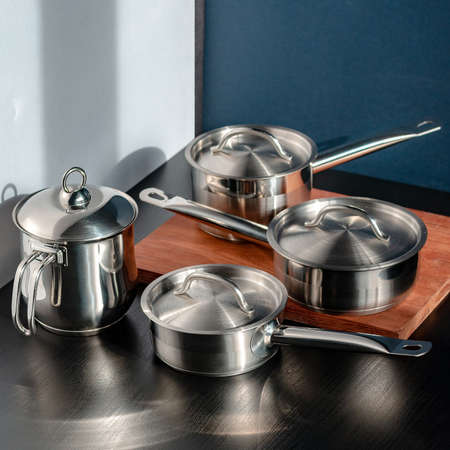Stainless steel pots and utensils on table counterの写真素材