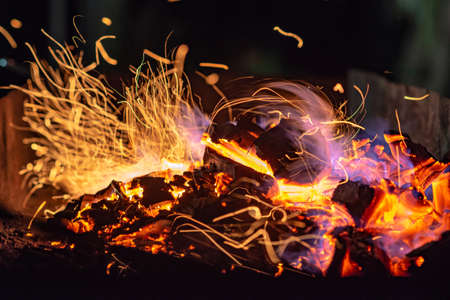 BBQ Grill Pit With Glowing And Flaming Hot Charcoal Briquettes, Food Background Or Texture, Close-Up, Top Viewの写真素材