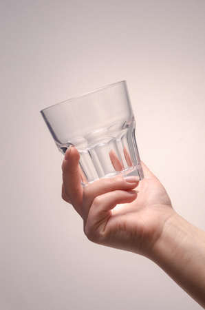 hand holding a glass on a white background. isolateの写真素材