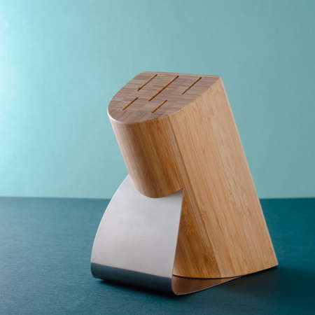 Woman Hands Pulling Out Stainless Steel Chefs Knives From A Bamboo Standの写真素材