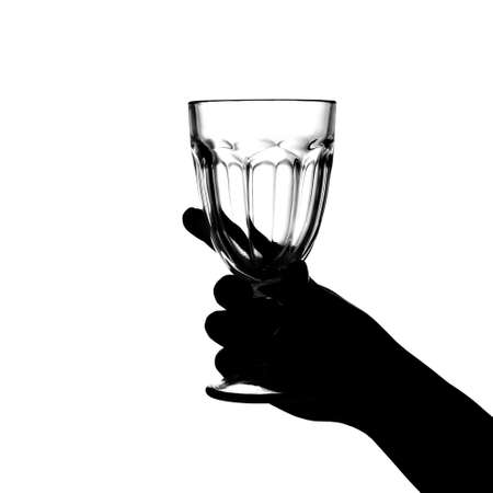 Hand holds a glass on a white background. isolate. Siluetの写真素材