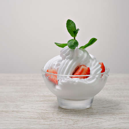 whipped cream in a cup with strawberries.の写真素材