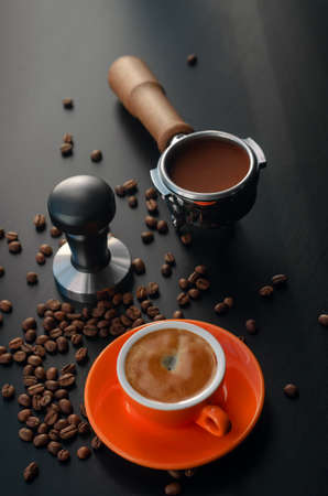 Tempera, holder, and orange barista cup with espresso. Equipment for making freshly brewed coffeeの写真素材