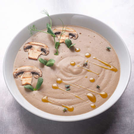 Cream soup with mushrooms, mushrooms and potatoes in a white bowlの写真素材