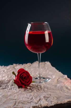 a glass of rose wine with a roseの写真素材