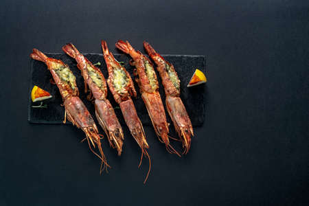 dishes with langoustines, in a plate on a black background. view from above. copyspace.の写真素材