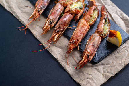 dishes with lobsters, on a serving board on a black background. view from above. copyspace. seafoodの写真素材