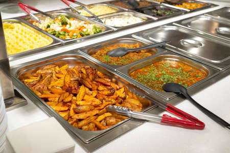 Side dishes on the serving line, self-service restaurant. steamed vegetables, rice, buckwheat,...