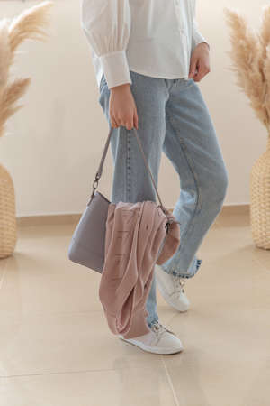 jeans, a blouse on a woman, a bag and a jacket in cookies. women's clothing store, show.の写真素材