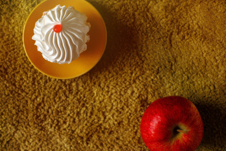 Tasty cake on a yellow plate. Apple on a green background, grass. Top view. Text placeの写真素材