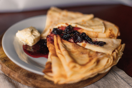 Stack of pancakes for breakfast with butter and jam. On a plate. Close viewの写真素材