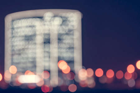 Defocused building of the night city. backgrounds, texture, bokeh, vintage. Place under the inscriptionの写真素材