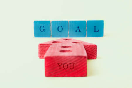 The red arrow indicates the blue cubes lined up in a row, from which the word "goal" is composed. The back of the arrow says "you."の写真素材