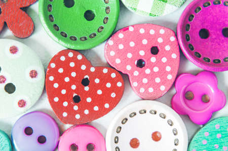 The background is made up of multicolored buttons of different sizes and shapes. Backgrounds,...