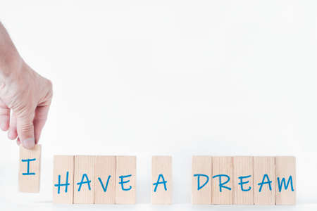 Motivational concept, concept of development, success, startup. The wooden blocks say "have a dream". The man's hand puts the letter I, it turns out "I have a dream"の写真素材