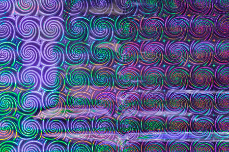 Photo of a multi-colored texture and background. Geometric repeating shapes in the form of a spiral.