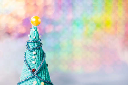 Image of a handmade Christmas tree on a multicolored background.の写真素材