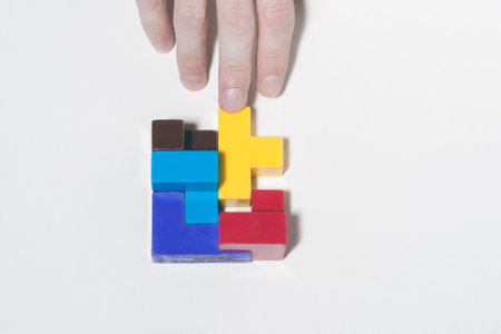 The concept of development, success, leadership, business. The hand drops the last block in the puzzle.の写真素材