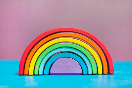 Rainbow from the children's designer. It stands on a blue table on a purple background.の写真素材